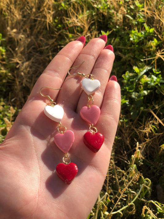 white, pink, and red chain of hearts earrings